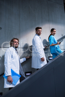 Doctors and nurse standing on staircase