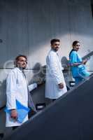 Doctors and nurse standing on staircase