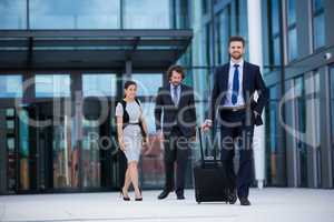 Businesswoman with colleagues walking