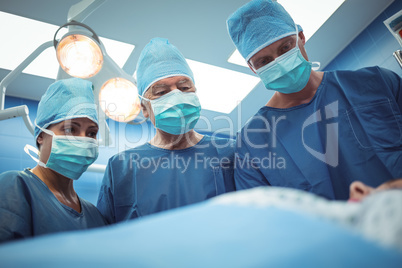 Team of surgeons performing operation in operation theater