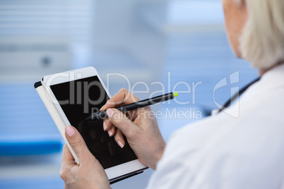 Doctor using digital tablet