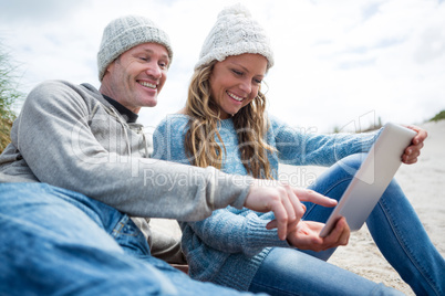 Smiling couple using digital tablet