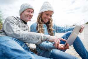 Smiling couple using digital tablet