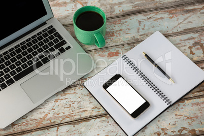 Laptop with smartphone and cup of coffee