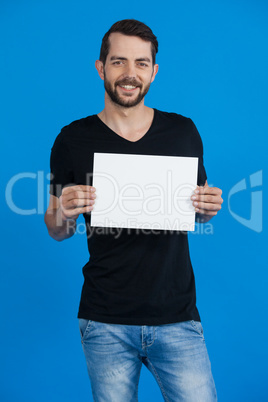 Handsome man holding a blank placard