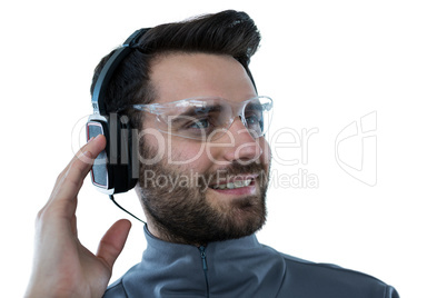 Man in protective glasses listening to headphones