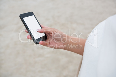 Mid section of woman using mobile phone