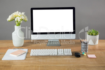 Desktop pc, flower vase and office stationery
