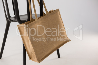 Jute bag hanging on a black chair