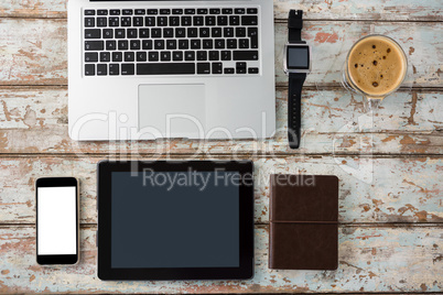 Laptop, smartwatch, smartphone and digital tablet with cup of coffee