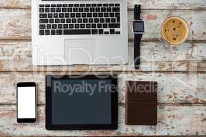 Laptop, smartwatch, smartphone and digital tablet with cup of coffee