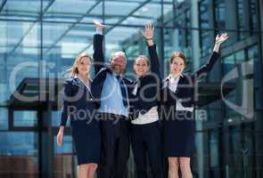 Cheerful businesspeople standing outside office