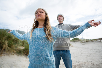 Couple standing with arms outstretched