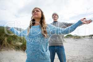 Couple standing with arms outstretched