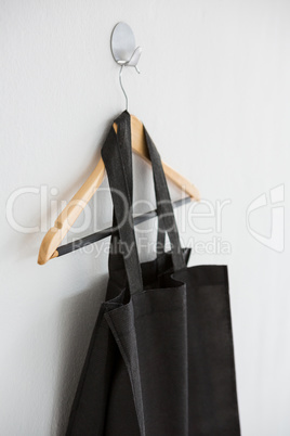 Black bag hanging on hanger