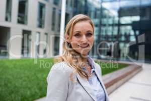 Smiling businesswoman standing in office premises