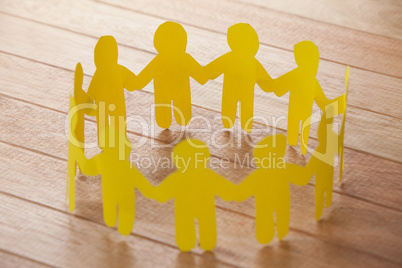 Paper cut outs forming a circle on wooden background