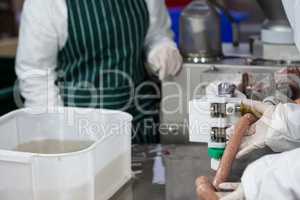 Butchers processing sausages