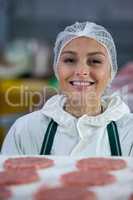 Female butcher at meat factory