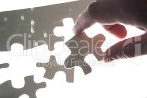 Man hands holding a puzzle piece