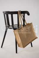 Jute bag hanging on a black chair