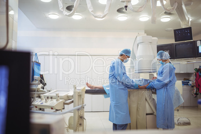 Surgeons examining patient in operation theater