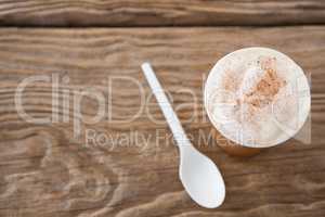 Coffee with spoon on wooden table