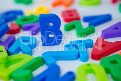 B alphabet standing between toy alphabet