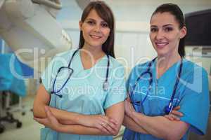 Portrait of two female nurse standing with arms crossed