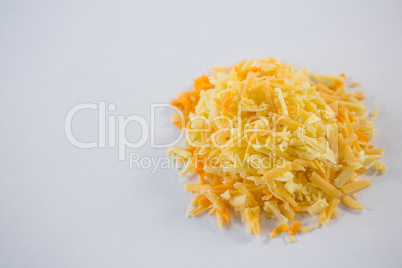 Heap of grated cheese on a white background