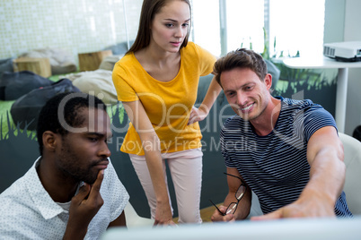 Graphic designers working on computer at desk