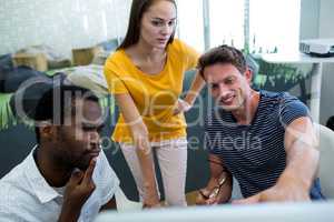 Graphic designers working on computer at desk