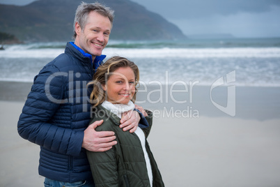 Romantic couple embracing each other on beach