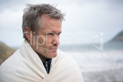 Thoughtful man wrapped in shawl