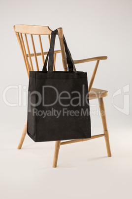Black bag hanging on a wooden chair