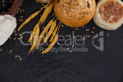 Bread loaves with flour and wheat grains