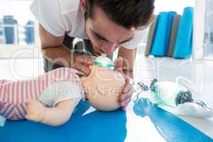 Paramedic blowing oxygen to dummy