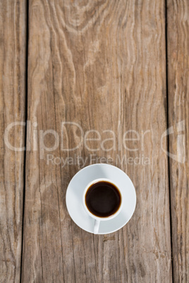 Cup of coffee with saucer on a wooden table