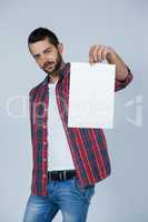 Confident man holding a blank placard
