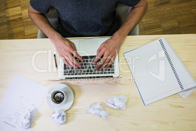 Graphic designer using digital tablet at his desk