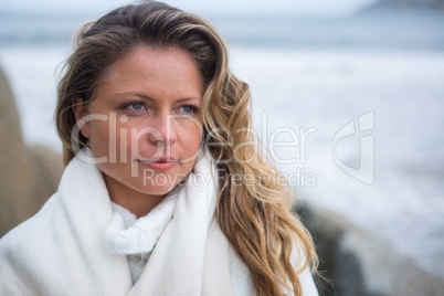 Thoughtful woman wrapped in shawl