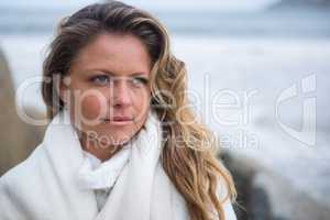 Thoughtful woman wrapped in shawl