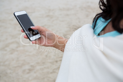 Mid section of woman using mobile phone