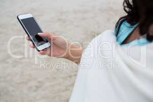 Mid section of woman using mobile phone