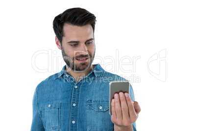 Smiling man looking at mobile phone