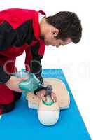 Paramedic practicing cardiopulmonary resuscitation on dummy