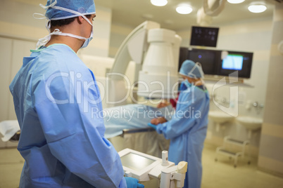 Surgeons examining patient in operation theater