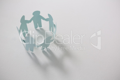 Circle of white paper cut-out figures