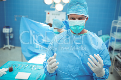 Portrait of male surgeon standing in operation theater