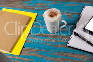Coffee mug, notepad, smartphone, pen and diary